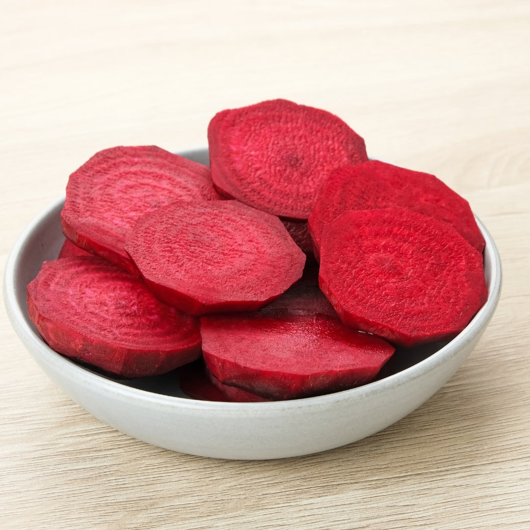 Freshly sliced organic beetroot online Mumbai in a white bowl on a wooden surface