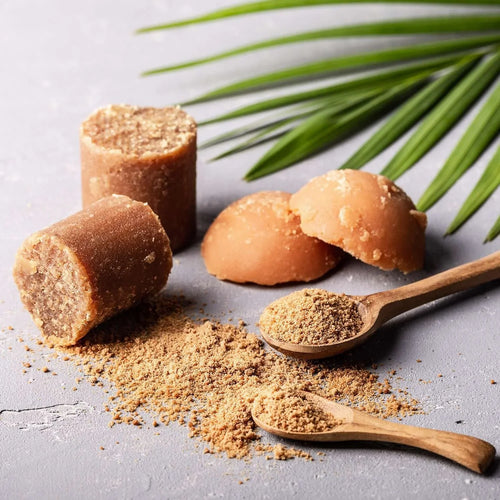 Organic jaggery online collection featuring solid blocks and granulated jaggery on a textured surface