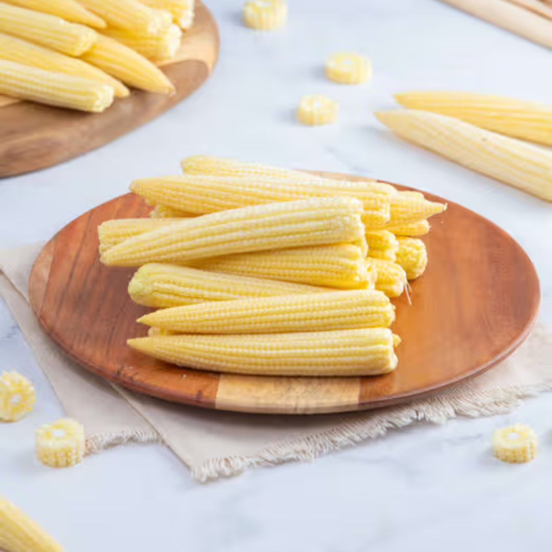 Fresh organic baby corn online on a wooden platter for healthy meals and snacks