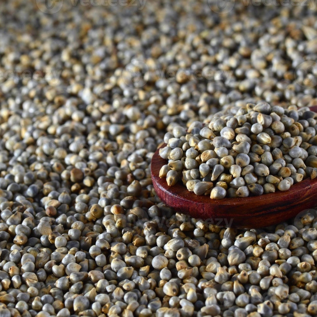 High-quality organic bajari online in a wooden scoop with scattered seeds