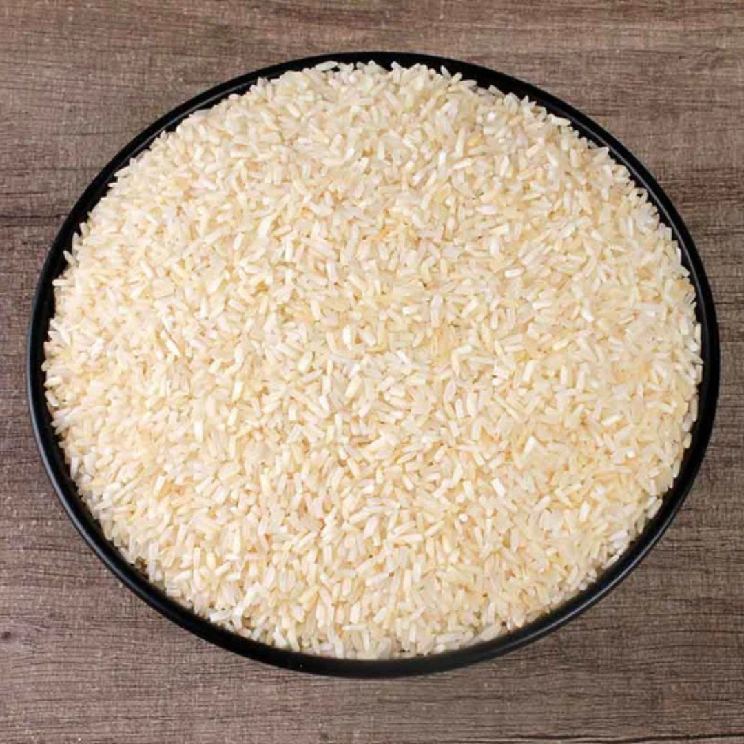 Organic basmati tukada rice in a black bowl on a wooden surface, perfect for healthy meals