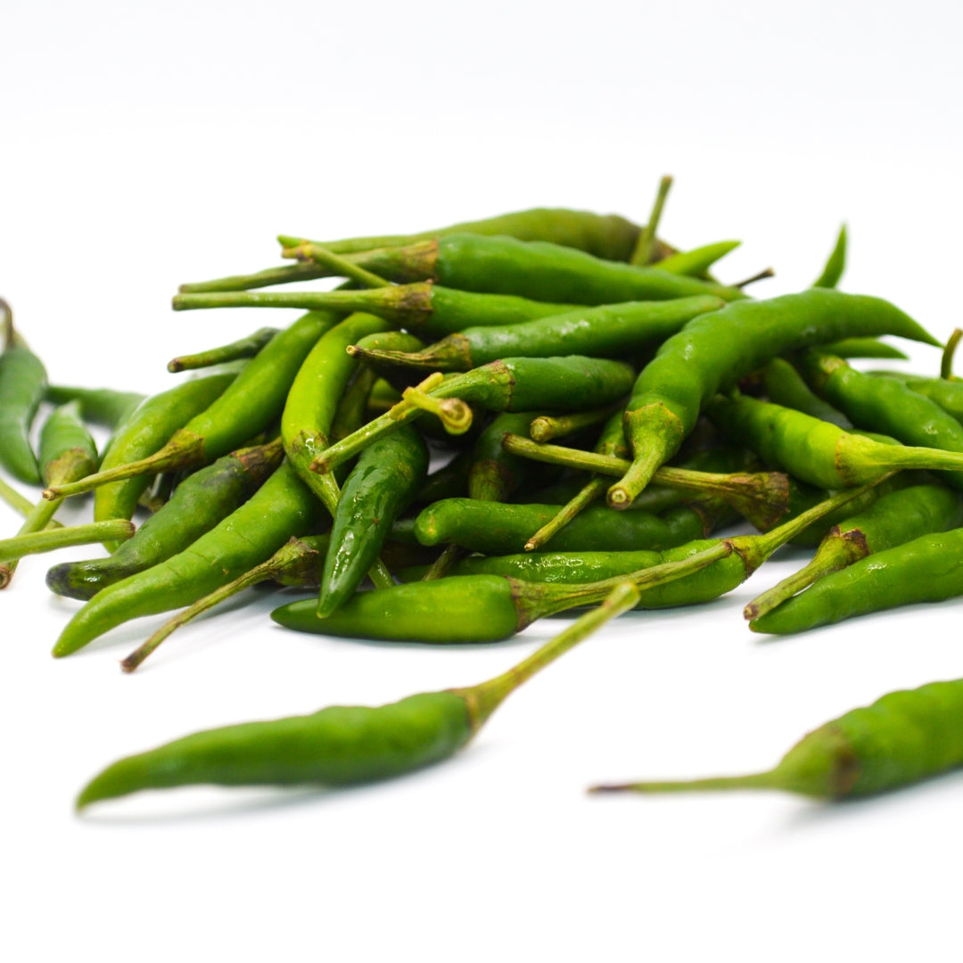 Fresh organic green chilli online Mumbai piled together for cooking and spices