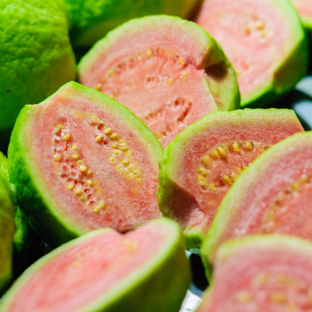 Fresh organic guava online Mumbai, showcasing ripe guava halves with pink flesh and green skin