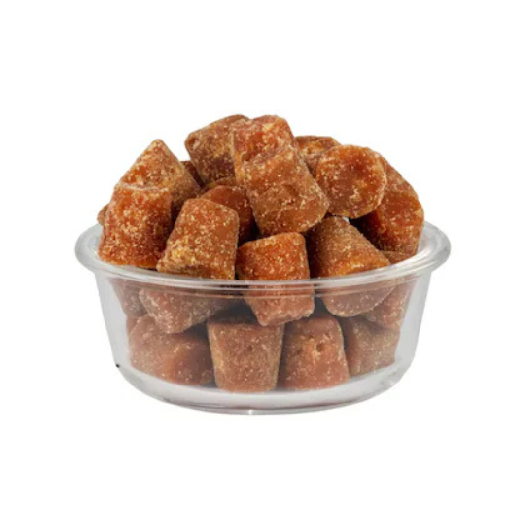 Organic jaggery cubes in a clear bowl, perfect for natural sweetening in recipes