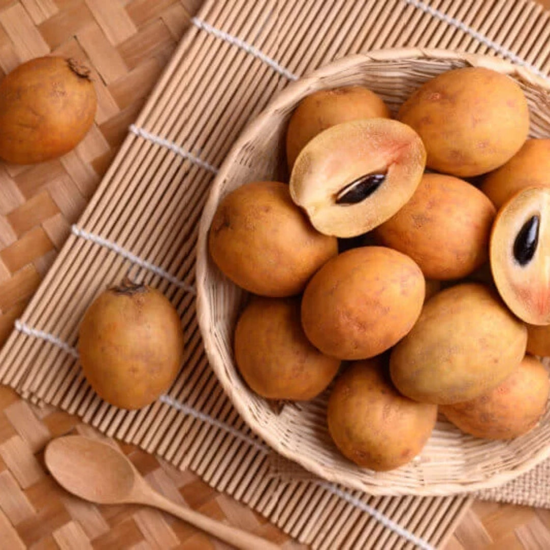 Fresh organic sapota online in a woven basket, showcasing ripe brown fruits with a sweet interior